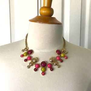 Costume jewelry, pink and green with gold necklace.